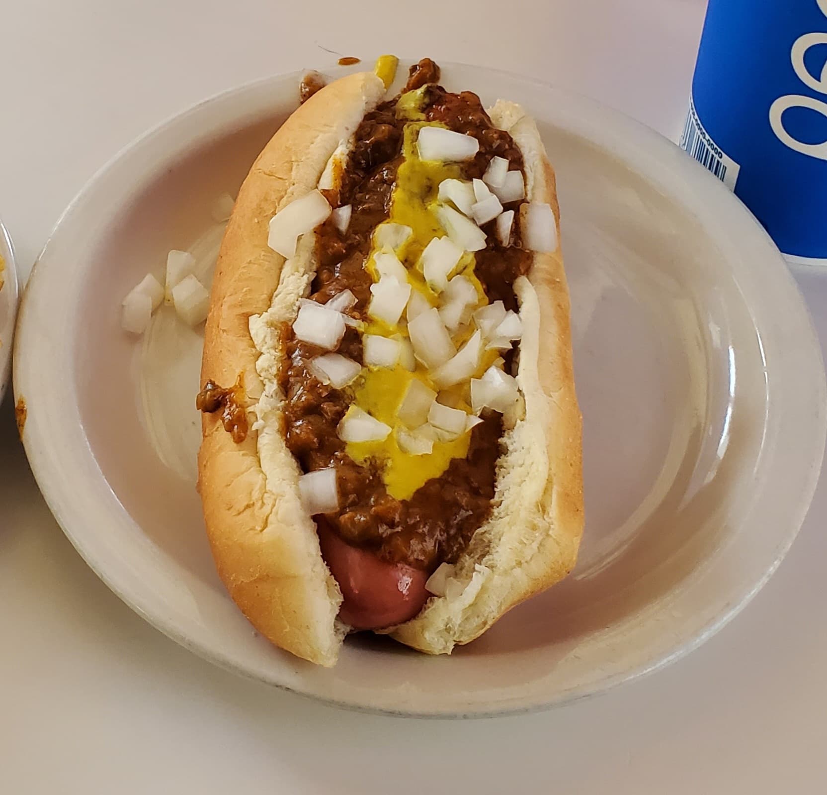 A Detroit coney dog with chili, mustard, and onions