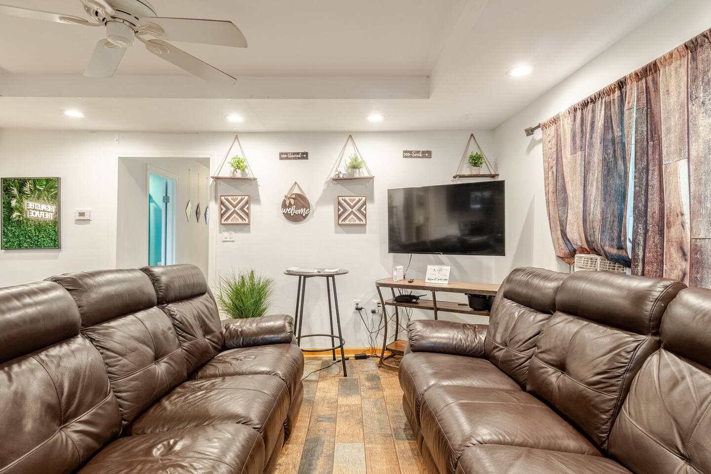 Living room with leather couches and a smart TV