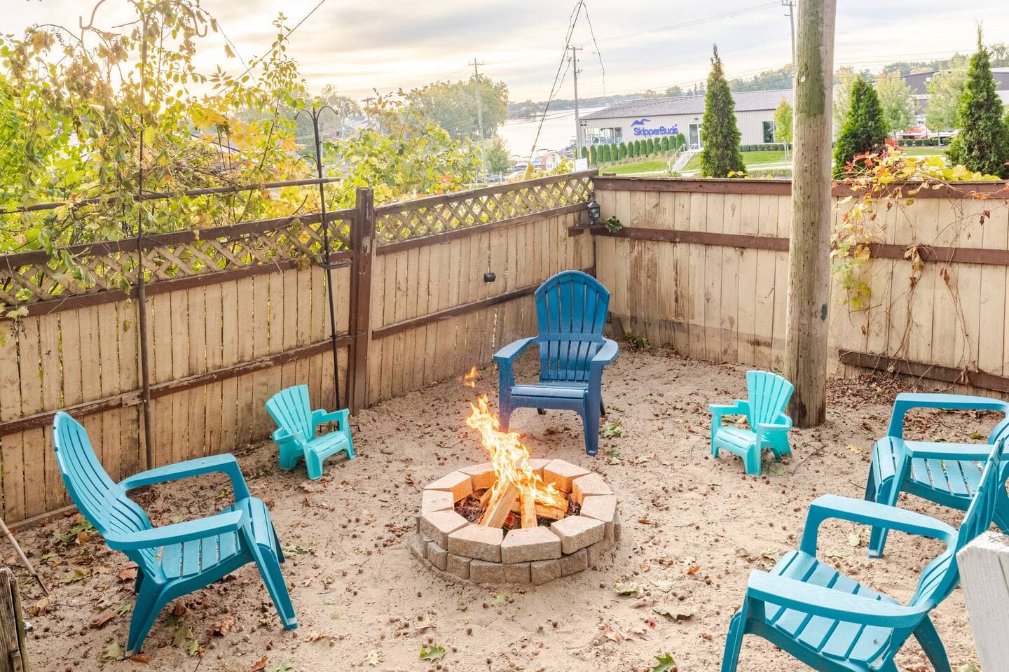 Sunken fire pit with Adirondack chairs at dusk