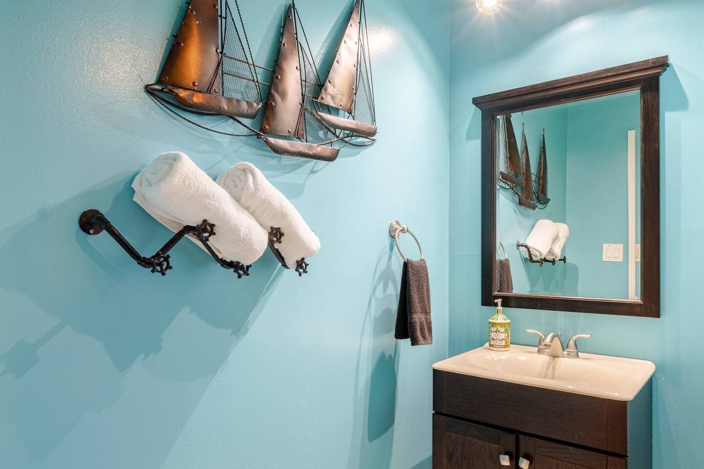 Teal full bathroom with nautical decor