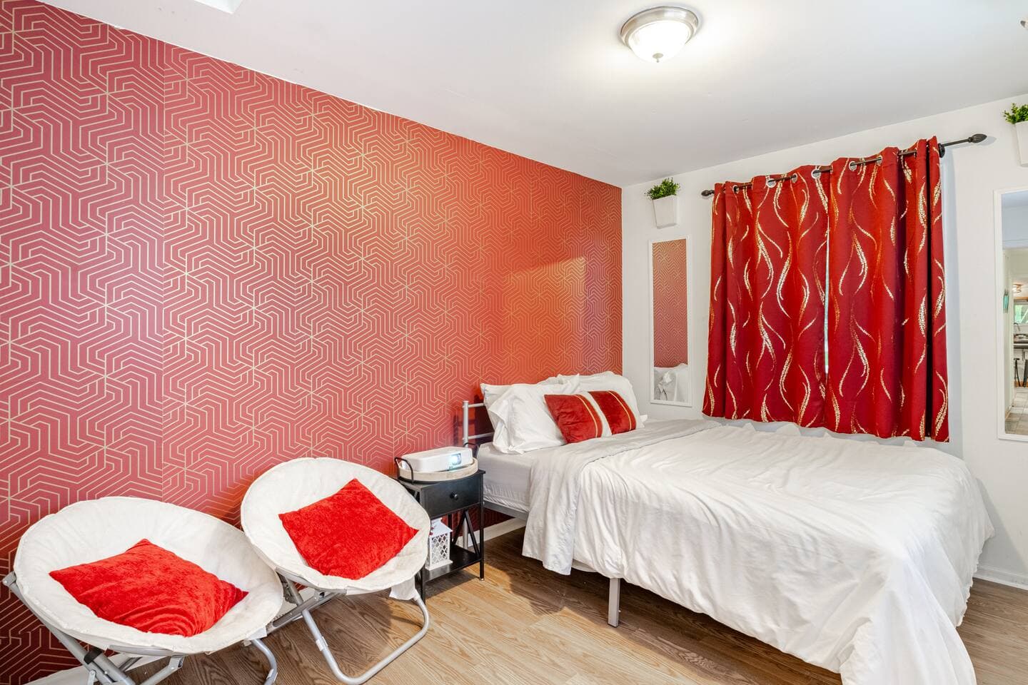 Bedroom 3 — red room with saucer chairs and projector